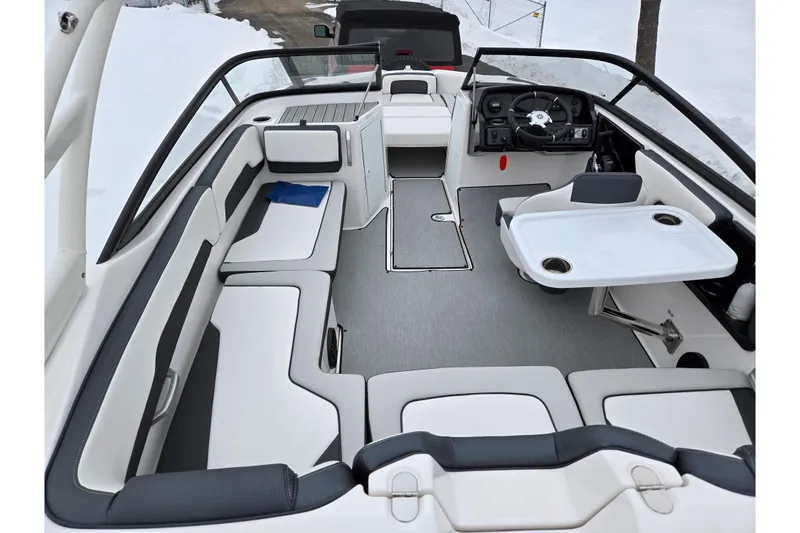 Slide: The Image of 2023 Yamaha Boats AR195 interior with seating, steering wheel, and table setup. - 10
