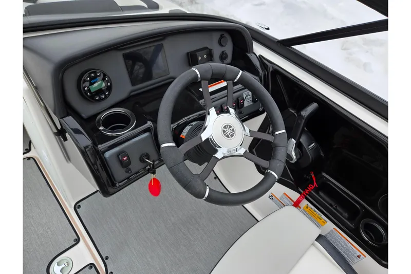 Slide: The Image of 2023 Yamaha Boats AR195 steering console with modern controls and sleek design. - 12
