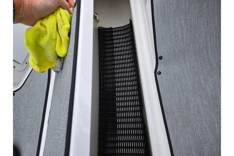 Slide: The Image of Cleaning the interior of a 2023 Yamaha AR195 boat with a yellow cloth. - 14