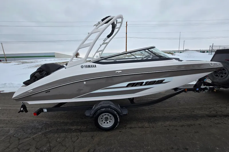Slide: The Image of 2023 Yamaha AR195 boat on trailer, parked on snowy pavement. - 4