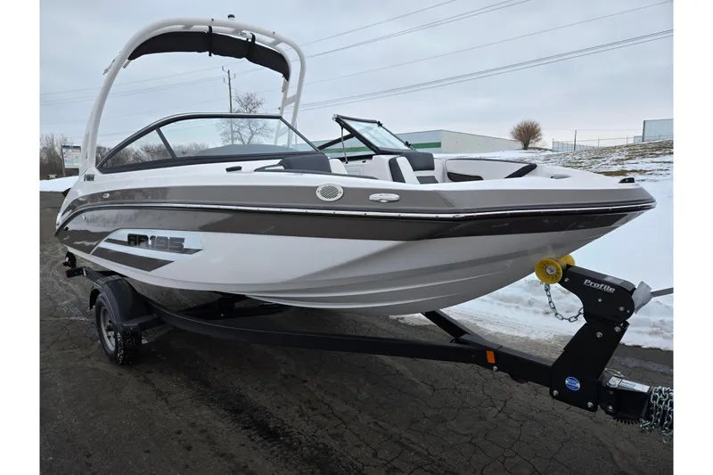 Slide: The Image of 2023 Yamaha Boats AR195 on trailer, sleek design, white and black exterior. - 5