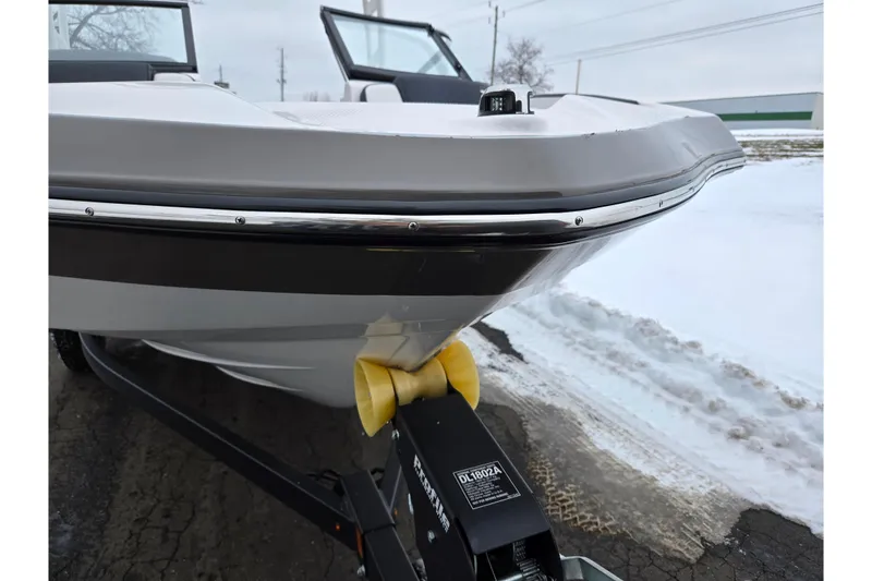 Slide: The Image of 2023 Yamaha Boats AR195 on trailer, snowy background, close-up of bow. - 6