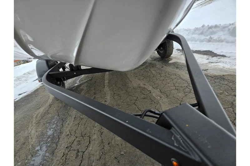 Slide: The Image of 2023 Yamaha Boats AR195 on trailer, snowy background, close-up view. - 7