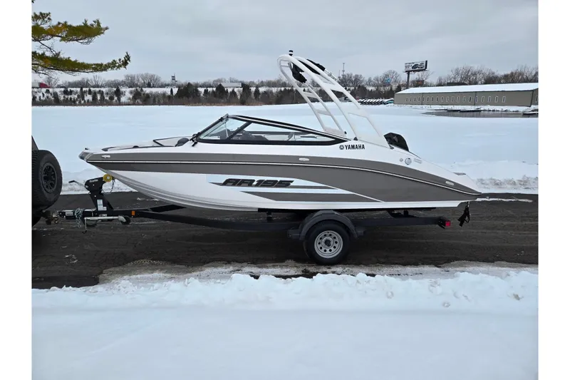 Slide: The Image of 2023 Yamaha Boats AR195 on trailer, parked on snowy ground. - 9