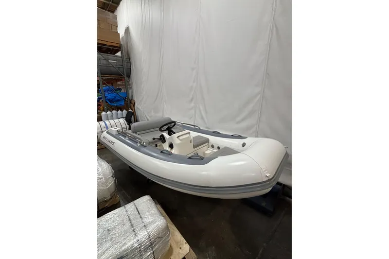 Slide: The Image of 2021 Williams Jet Tenders Sportjet 345 in storage, white inflatable boat. - 2