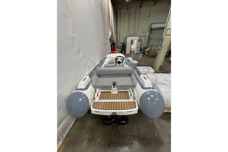 Slide: The Image of 2021 Williams Jet Tenders Sportjet 345 in warehouse, showcasing sleek design and seating. - 3