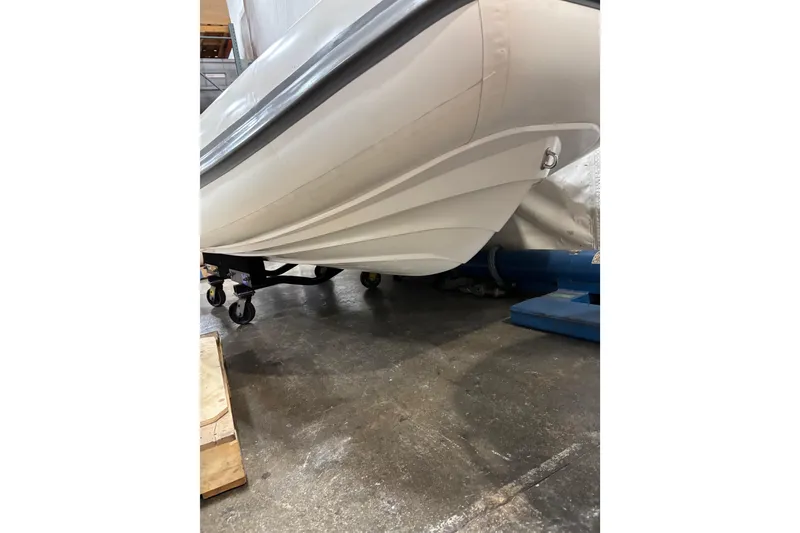 Slide: The Image of 2021 Williams Jet Tenders Sportjet 345 hull on a wheeled stand in a warehouse. - 8