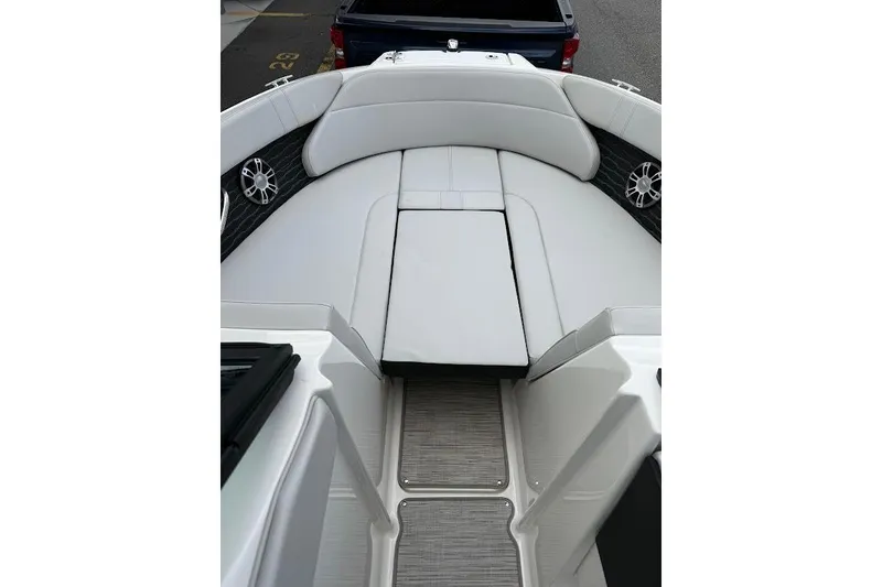Slide: The Image of 2023 Sea Ray SPX 230 boat interior with white seating and modern design. - 11