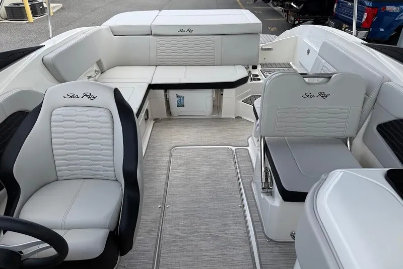 Slide: The Image of 2023 Sea Ray SPX 230 boat interior with luxurious white seating and modern design. - 13