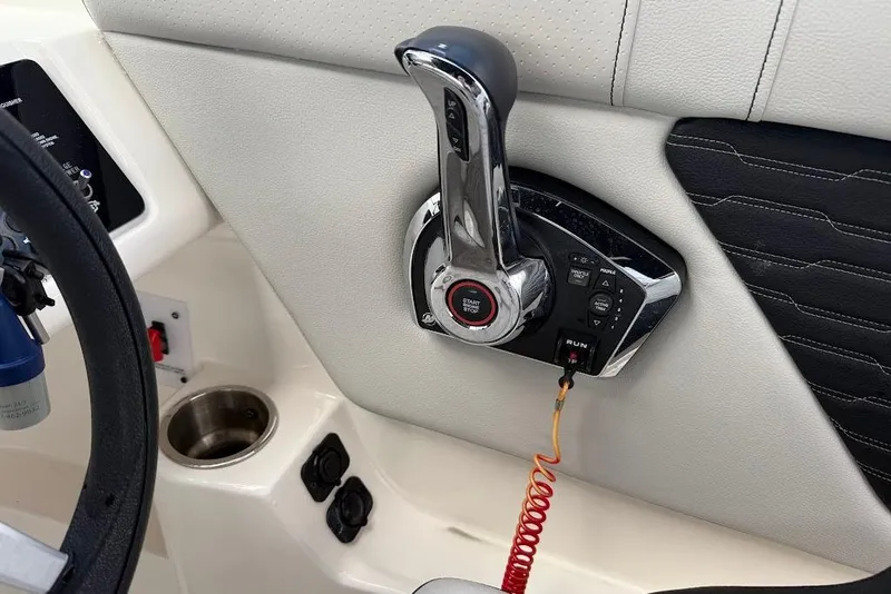 Slide: The Image of 2023 Sea Ray SPX 230 boat throttle control with start/stop button and cup holder. - 17