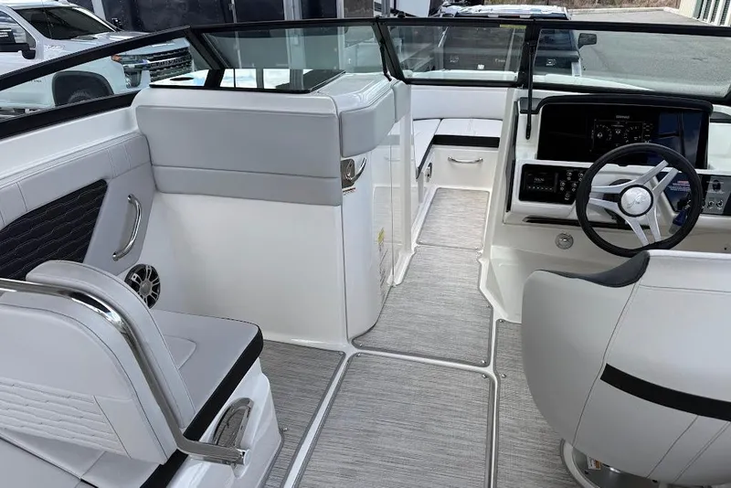 Slide: The Image of 2023 Sea Ray SPX 230 boat interior with modern helm and seating. - 18