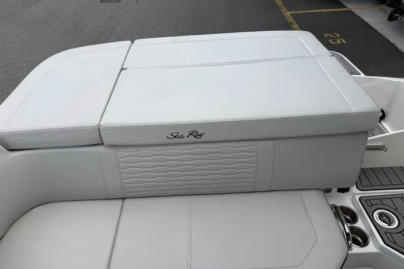Slide: The Image of 2023 Sea Ray SPX 230 boat with white cushioned seating and elegant design. - 23