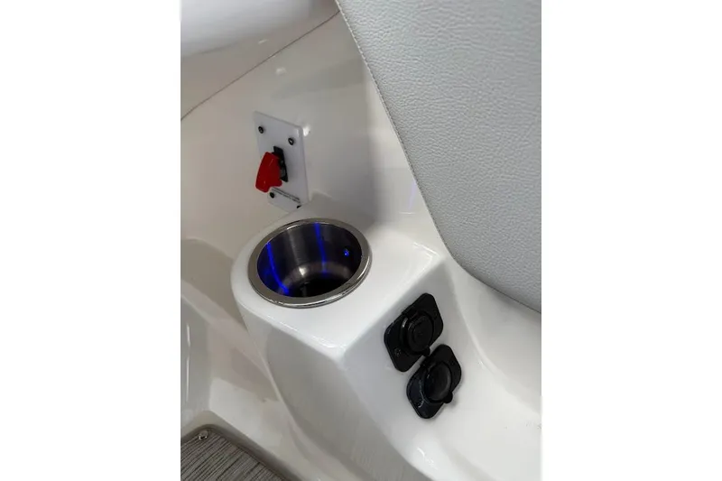 Slide: The Image of 2023 Sea Ray SPX 230 boat interior with cup holder and control panel. - 25