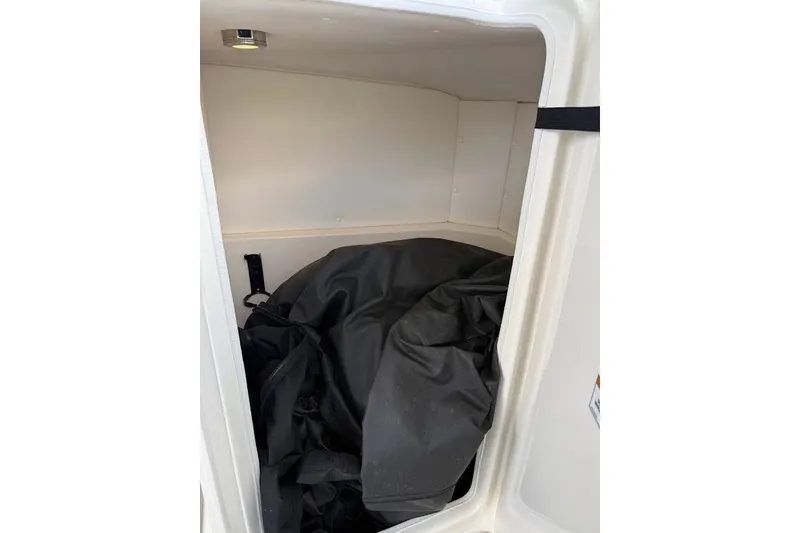 Slide: The Image of Storage compartment of 2023 Sea Ray SPX 230 boat with black cover inside. - 30