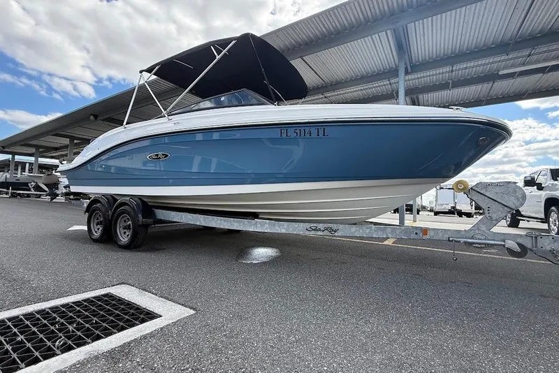 Slide: The Image of 2023 Sea Ray SPX 230 boat on trailer under covered parking. - 5