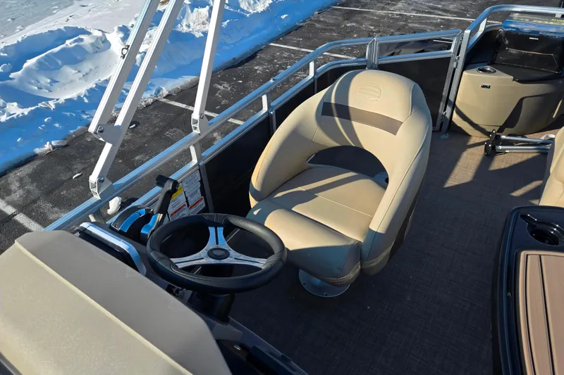 Slide: The Image of 2024 Sun Tracker Fishin' Barge 20 DLX interior with steering wheel and seating. - 13