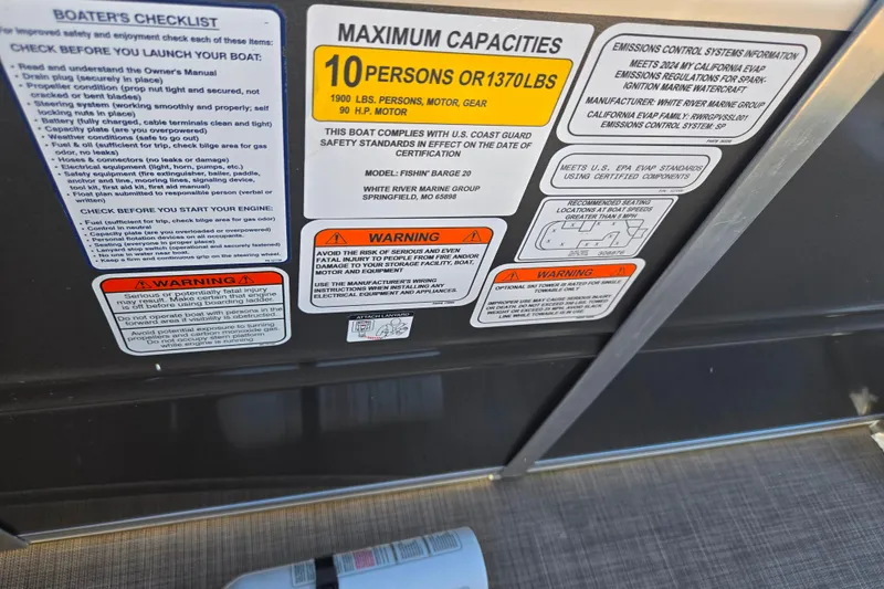 Slide: The Image of 2024 Sun Tracker Fishin' Barge 20 DLX capacity and safety labels on boat interior. - 14