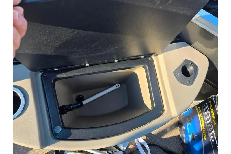 Slide: The Image of 2024 Sun Tracker Fishin' Barge 20 DLX livewell compartment with open lid and accessories. - 16