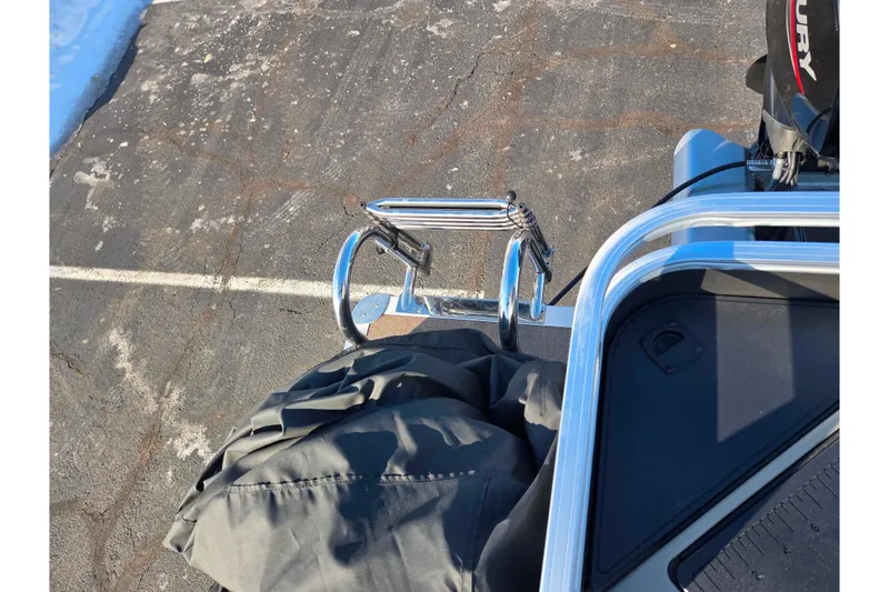 Slide: The Image of 2024 Sun Tracker Fishin' Barge 20 DLX rear view with ladder and Mercury engine. - 17