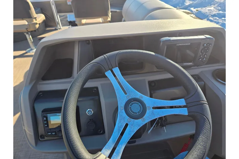 Slide: The Image of 2024 Sun Tracker Fishin' Barge 20 DLX steering console with navigation equipment. - 20