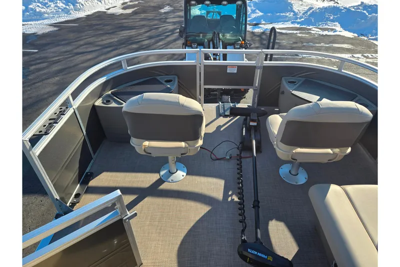 Slide: The Image of 2024 Sun Tracker Fishin' Barge 20 DLX interior with seating and fishing equipment. - 22