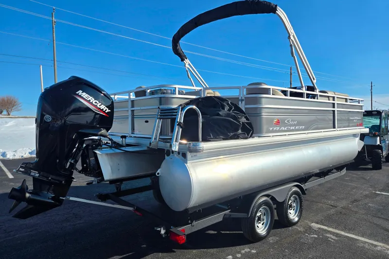 Slide: The Image of 2024 Sun Tracker Fishin' Barge 20 DLX pontoon boat with Mercury engine on trailer. - 3