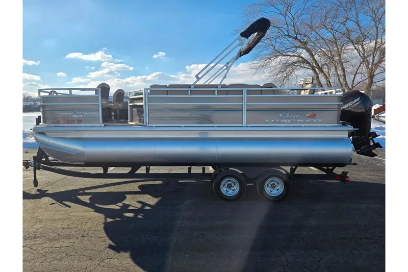 Slide: The Image of 2024 Sun Tracker Fishin' Barge 20 DLX pontoon boat on trailer, sunny day. - 9