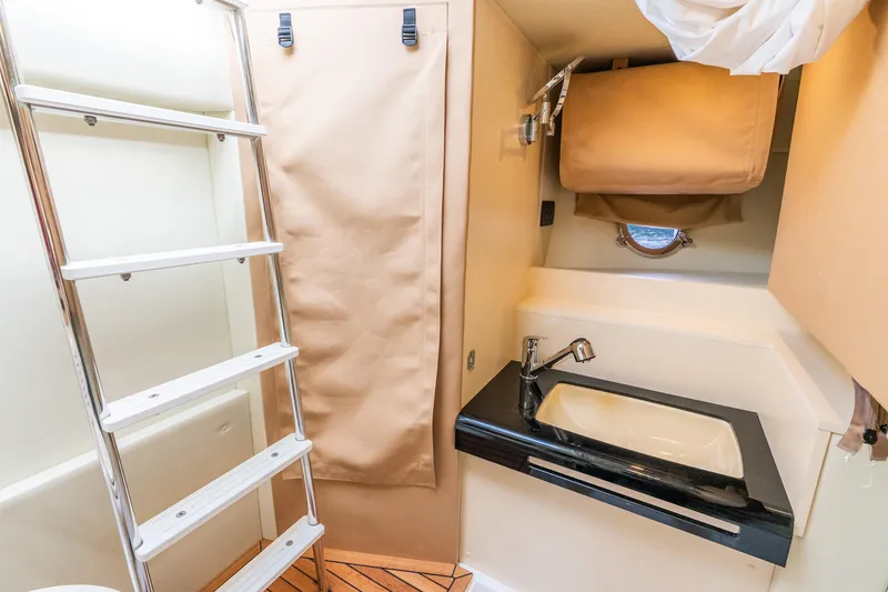 Slide: The Image of 2021 Azimut S6 yacht interior bathroom with sink, ladder, and porthole window. - 42