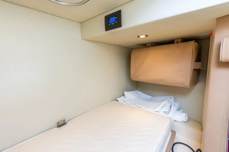 Slide: The Image of 2021 Azimut S6 yacht interior cabin with bed and storage compartment. - 44