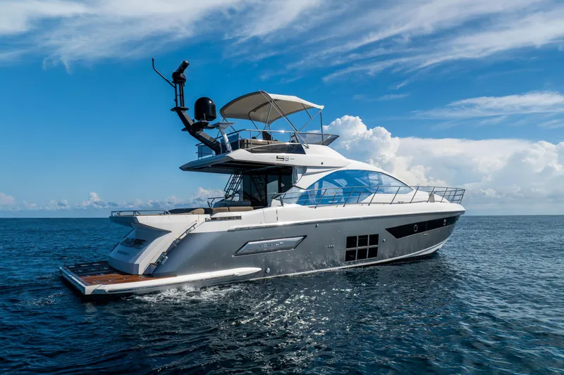 Slide: The Image of Luxury Azimut S6 yacht cruising near waterfront homes, 2021 model. - 6