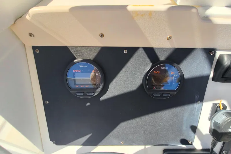 Slide: The Image of 1995 Mako 201 Center Console dashboard with Yamaha speed and tachometer gauges. - 10