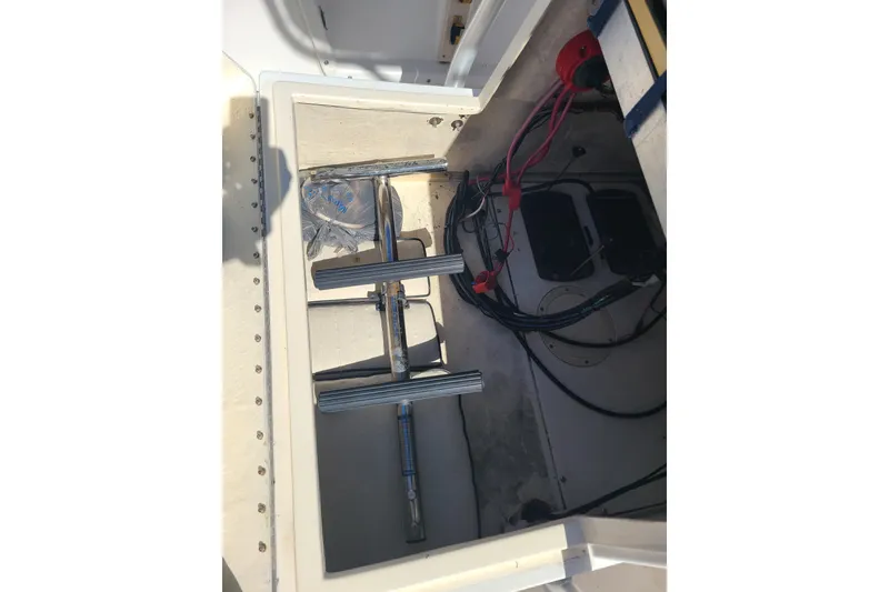 Slide: The Image of Open storage compartment in 1995 Mako 201 Center Console boat, showing wiring and equipment. - 19