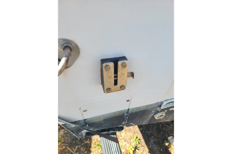 Slide: The Image of Close-up of a 1995 Mako 201 Center Console boat's metal latch and fittings. - 3