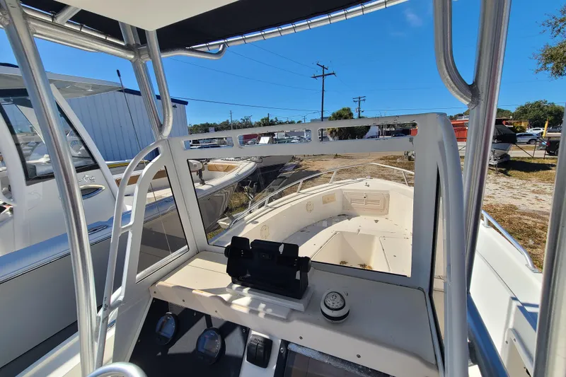 Slide: The Image of 1995 Mako 201 Center Console boat interior with steering console and open deck view. - 7