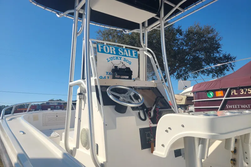 Slide: The Image of 1995 Mako 201 Center Console boat for sale, featuring steering wheel and console details. - 8