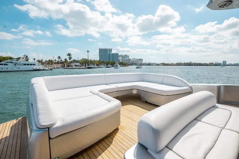 Slide: The Image of Luxurious 2014 Riva 86' DOMINO yacht with spacious deck seating, overlooking marina. - 16
