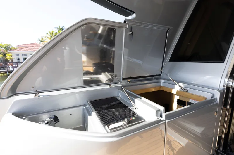 Slide: The Image of Outdoor kitchen area on 2014 Riva 86' DOMINO yacht, featuring grill and storage compartments. - 19