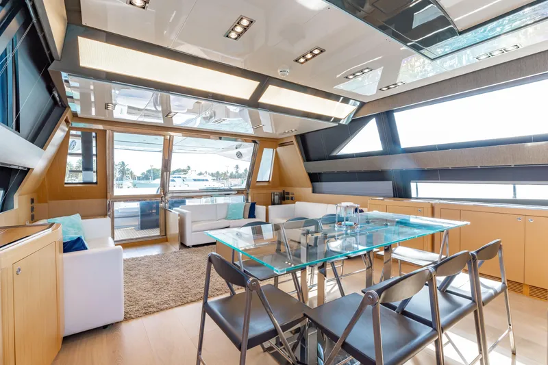 Slide: The Image of Luxurious interior of 2014 Riva 86' DOMINO yacht with modern furnishings and glass dining table. - 25