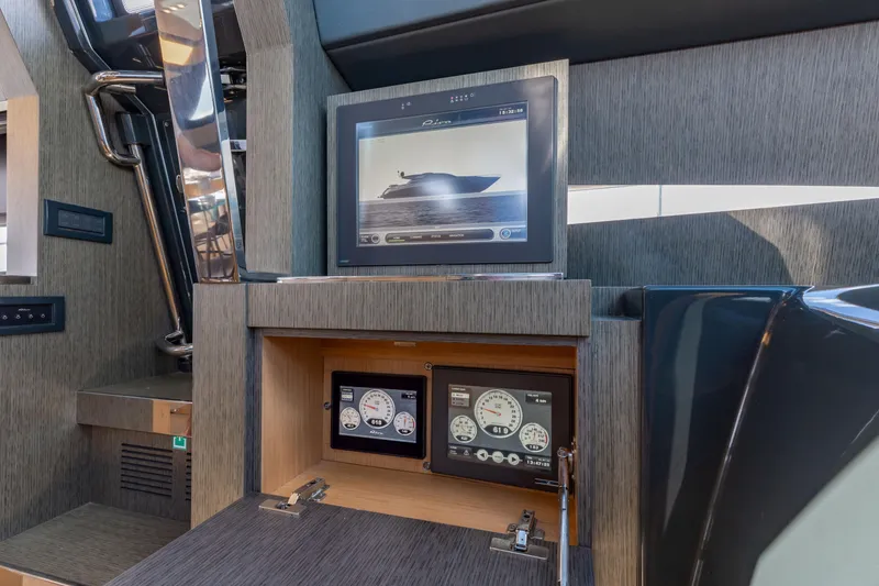 Slide: The Image of Control panel of 2014 Riva 86' DOMINO yacht with digital displays and sleek design. - 37