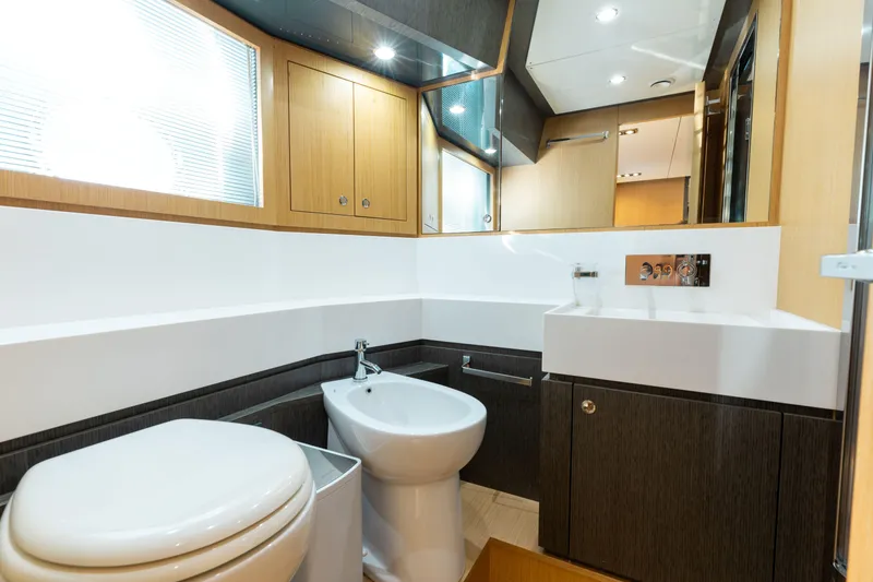 Slide: The Image of Luxurious bathroom interior on 2014 Riva 86' DOMINO yacht, featuring modern fixtures and wood accents. - 40