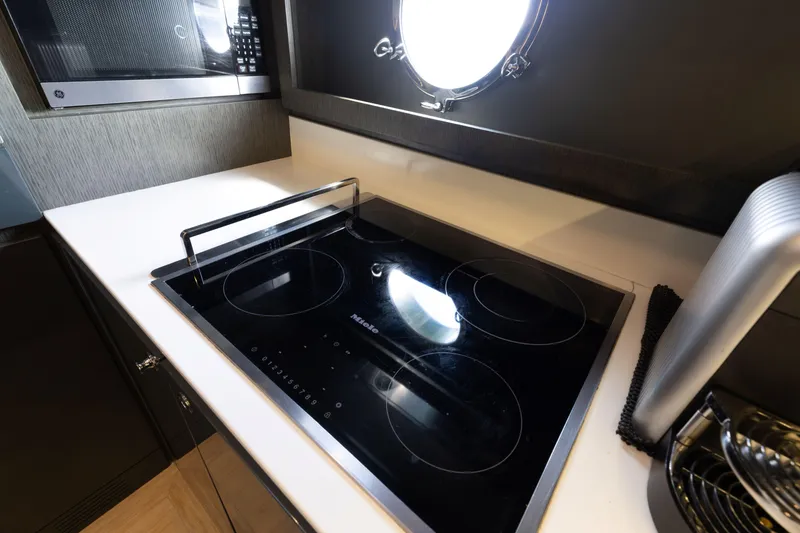 Slide: The Image of Modern kitchen in 2014 Riva 86' DOMINO yacht with sleek stovetop and microwave. - 58