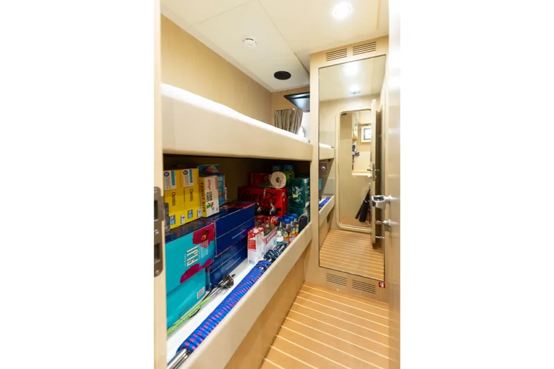 Slide: The Image of Storage area inside 2014 Riva 86' DOMINO yacht, featuring shelves with various supplies. - 64