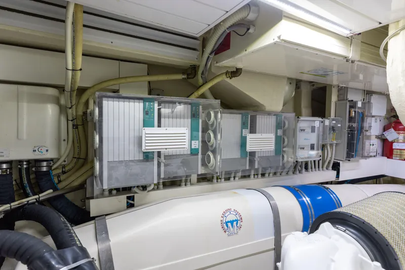 Slide: The Image of Engine room of 2014 Riva 86' DOMINO yacht with control panels and piping. - 79