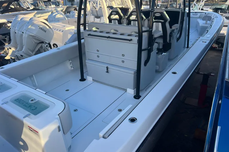 Slide: The Image of 2026 Contender 39 ST boat interior with seating and storage, docked alongside other boats. - 10