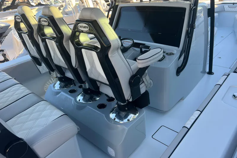 Slide: The Image of 2026 Contender 39 ST boat interior with sleek seating and modern dashboard. - 12