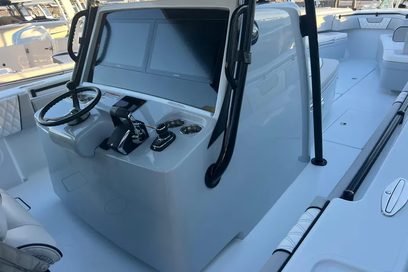 Slide: The Image of 2026 Contender 39 ST boat cockpit with modern steering and dual screens. - 13