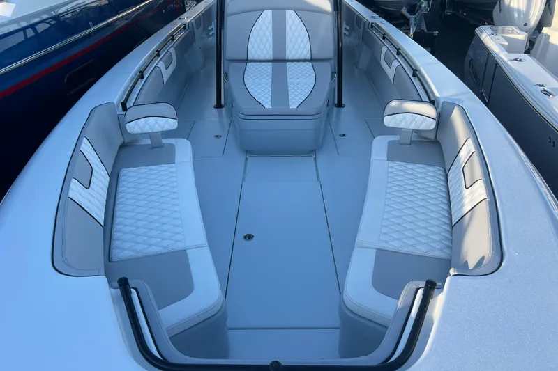 Slide: The Image of 2026 Contender 39 ST boat interior with white cushioned seating and sleek design. - 16
