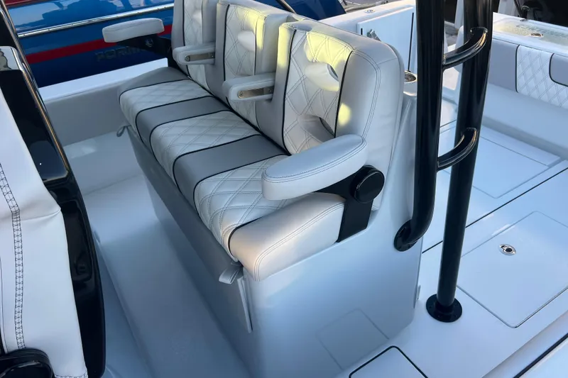 Slide: The Image of Luxurious seating on 2026 Contender 39 ST boat, featuring white leather upholstery and armrests. - 20