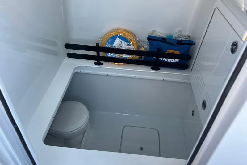 Slide: The Image of Interior of 2026 Contender 39 ST boat featuring storage and toilet area. - 22