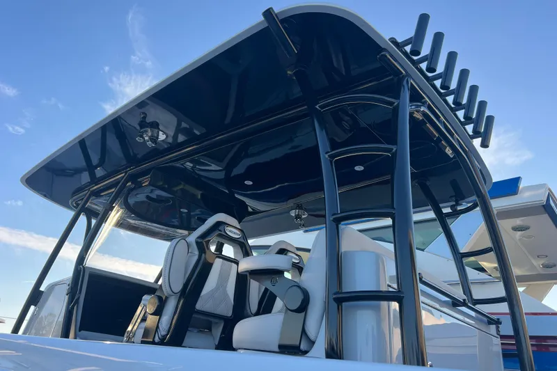 Slide: The Image of 2026 Contender 39 ST boat with sleek design and modern seating under a blue sky. - 23